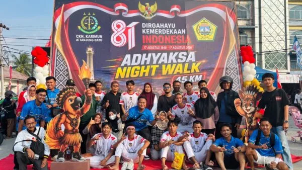 Peserta dan panitia foto bersama di depan baliho Adhyaksa Night Walk 45 KM Kundur.